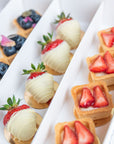 Fruit set by Batida - mini fruit tarts with yuzu cream and fresh fruit, close-up