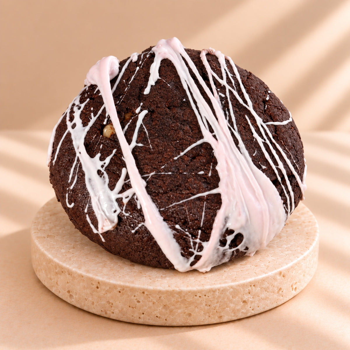 Chocolate crumble cookie with an icing spiderweb, close-up from above