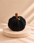 Pumpkin Latte Black - black pumpkin-shaped individual dessert with a cinnamon stick