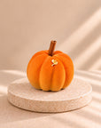 Pumpkin Latte - orange pumpkin-shaped individual dessert on a stone stand