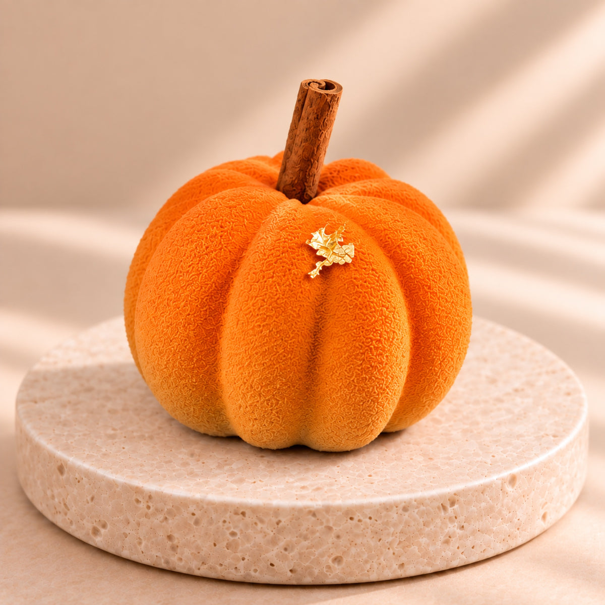 Orange Pumpkin Latte pumpkin with a cinnamon stick and a gold leaf flake