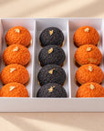 Halloween mini choux pastries with gold flakes in a box, top view